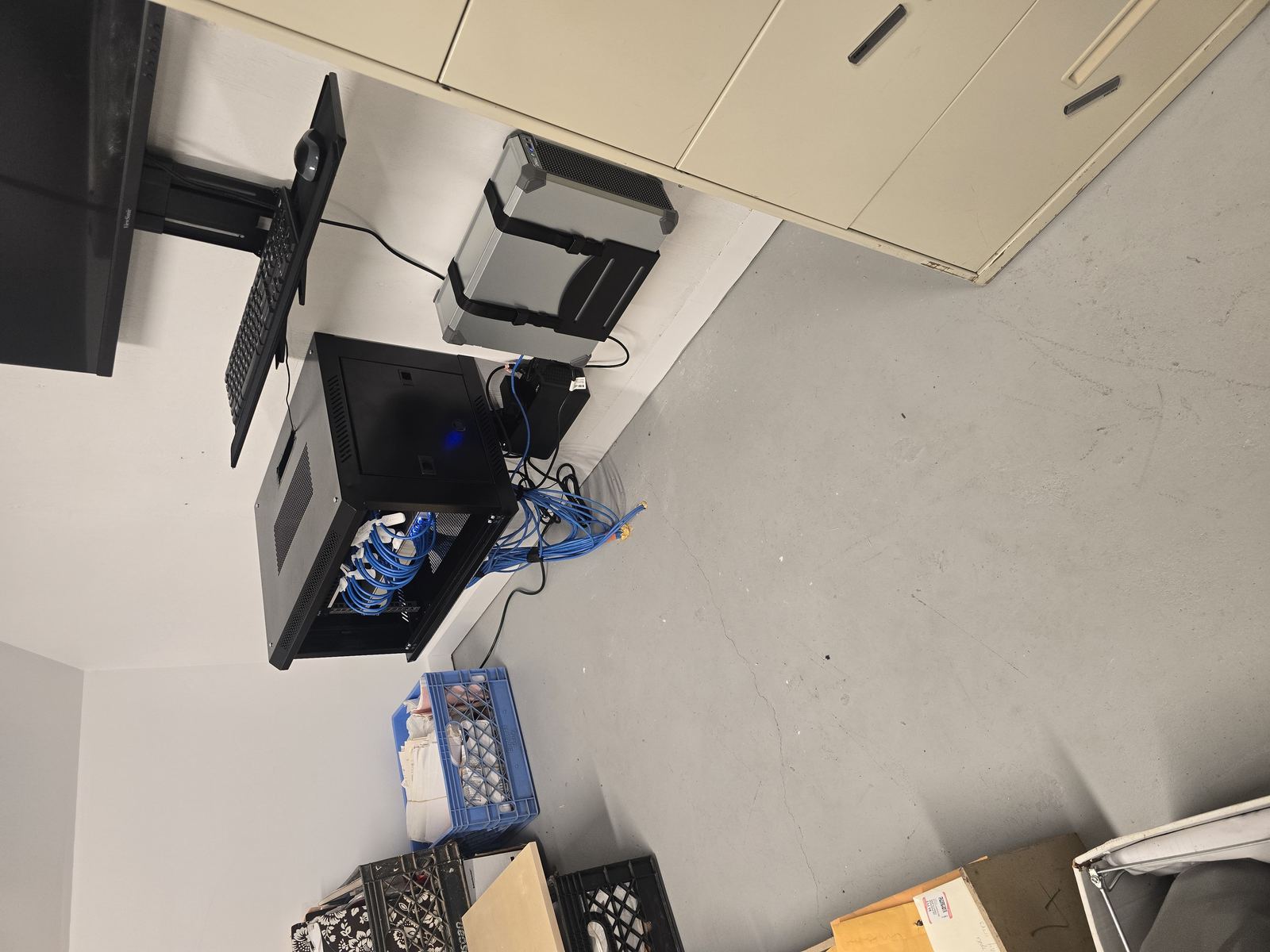 Two-desk office layout with cabinetry and security camera